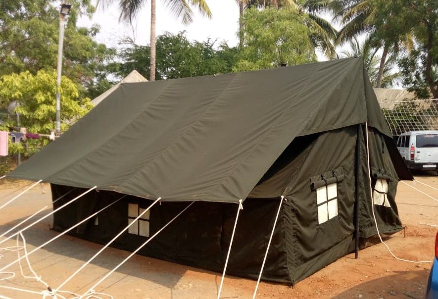 Olive green double fly canvas tent with windows, pitched with guy ropes