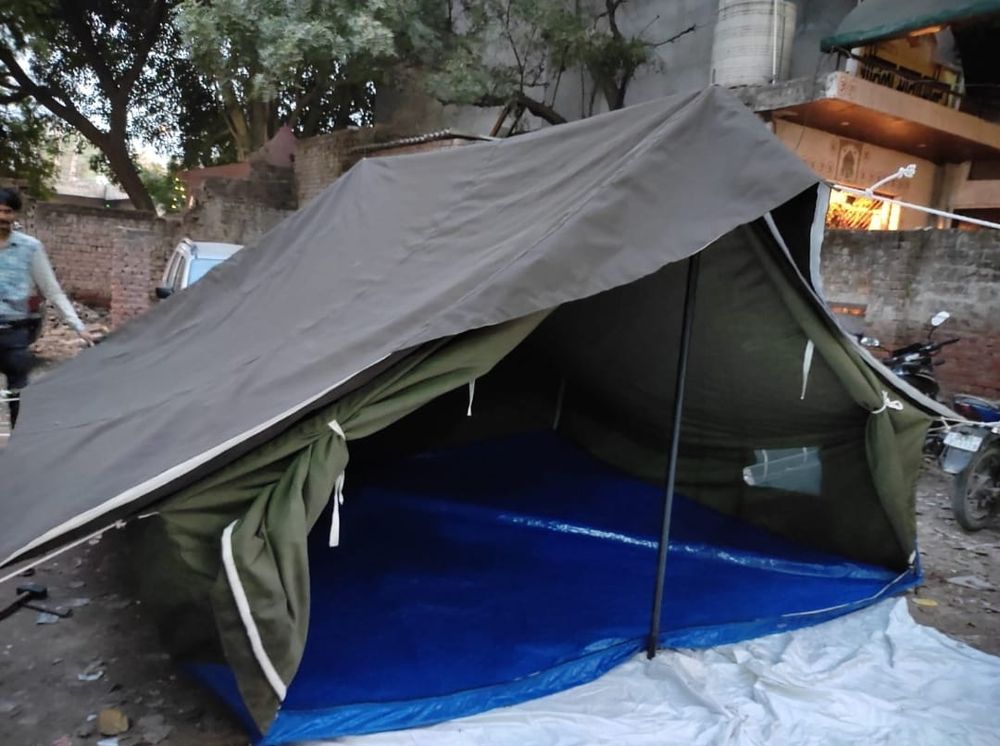 Double fly tent with the outer fly lifted to show the inner fly and ground sheet