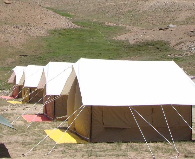 Row of double fly tents at a mountain camp