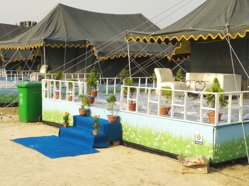 Swiss cottage resort tents with decks and seating in front